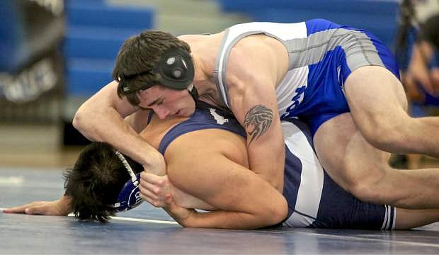 Carson&#039;s Bryce Newhall wrestles Christopher Perez Wednesday evening at Damonte High.