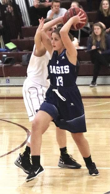 Oasis Academy&#039;s Emma Robinson passes the ball past a Sierra Lutheran player during the Lady Bighorns&#039; opening game of the season.