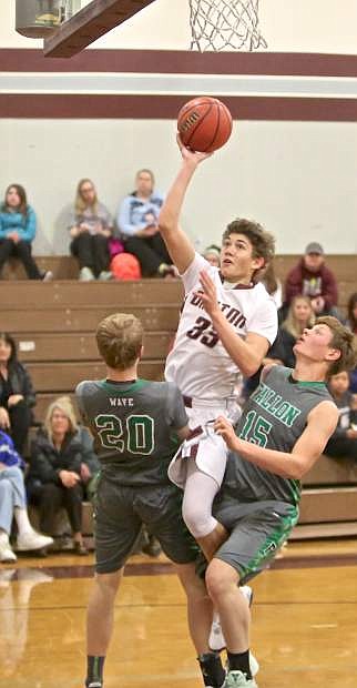 Dayton&#039;s Tyler Stolfich is sandwiched by a pair of Fallon defenders Friday night at Dayton High.