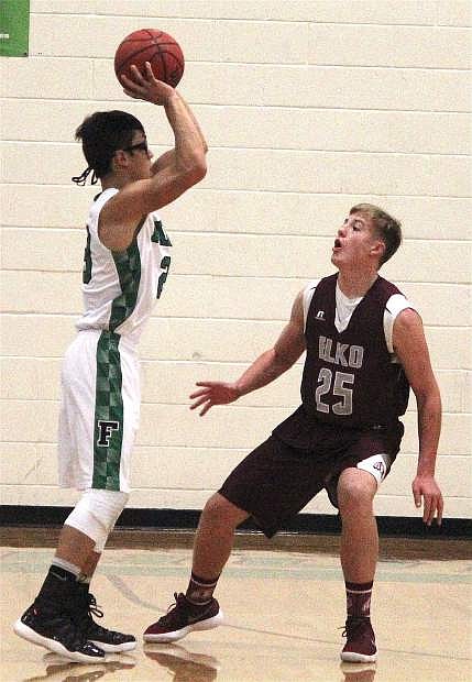Christian Nemeth looks for an opening around Elko&#039;s Ronin Rowley to pass the ball to a teammate