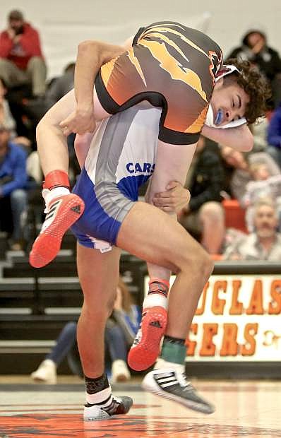 Carson&#039;s Luis Mayoral lifts Douglas&#039; Jayden Blanchard in a 113-lb. match Wednesday evening at DHS.