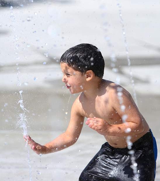 A youngster cools off during a summer heat wave.