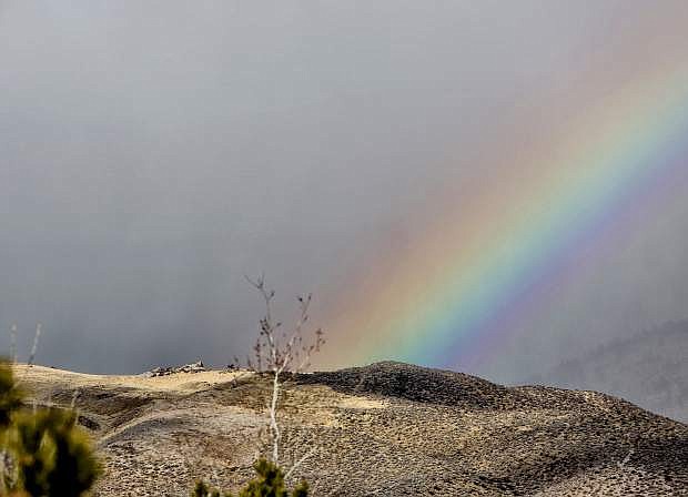 A rainbow is seen from Indian Hills as a storm moves across the mountains Saturday morning.
