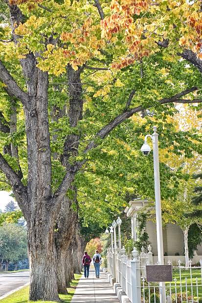 A pair of women recently walk along West Robinson St. adjacent to the Governor&#039;s Mansion as the fall colors take shape. The fall weather we&#039;ve been enjoying, though, is expected to give way to a winter storm this weekend.