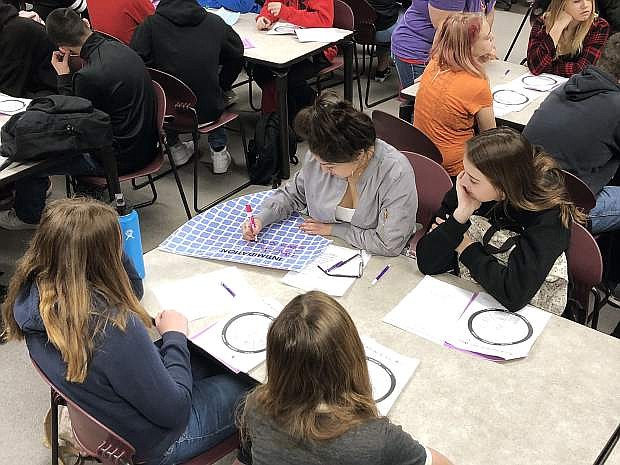 Carson High School students work on identifying different types of dating violence in media for Teen Dating Awareness month.
