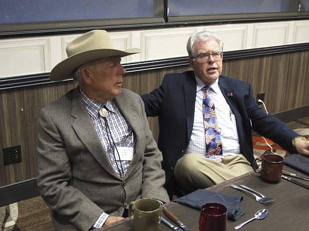 Southern Nevada rancher Cliven Bundy, left, listens to Independent American Party of Nevada Chairman Joel Hansen before Bundy was scheduled to give the keynote address to the third-party&#039;s state convention at the Nugget hotel-casino, Friday, Feb. 23, 2018, in Sparks, Nev. Bundy served 700 days in jail before a U.S. judge in Las Vegas threw out the criminal charges against him and others last month stemming from an armed standoff with federal agents at his ranch near Bunkerville in April 2014. (AP Photo/Scott Sonner)