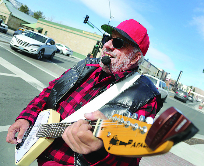 Chris Kay aka &quot;The Traveling Troubadour&quot; sings and plays his guitar in downtown Carson City on Tuesday.