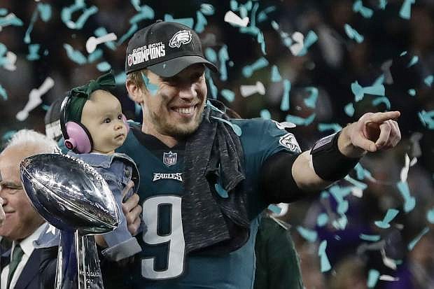 Philadelphia Eagles&#039; Nick Foles holds his daughter, Lily, after beating the New England Patriots in the NFL Super Bowl 52 football game Sunday, Feb. 4, 2018, in Minneapolis. (AP Photo/Frank Franklin II)