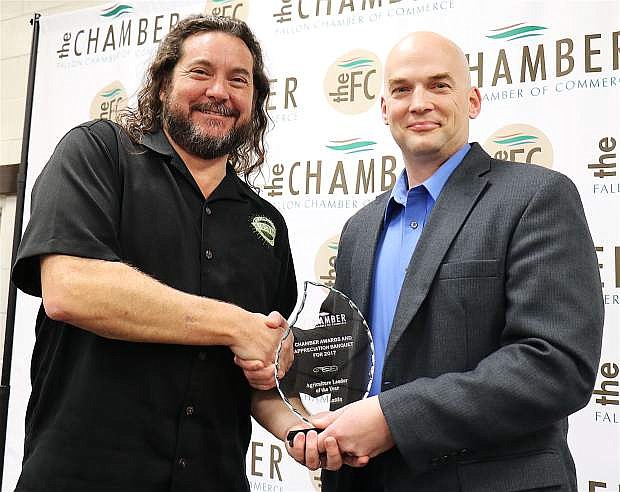 Executive Director of the Churchill Economic Development Authority, Nate Strong, left, accepts Agricultural Leader of the Year award on behalf of the winner Rick Lattin, presented by Churchill County Sheriff Ben Trotter, right during the Fallon Chamber of Commerce awards ceremony at the Fallon Convention Center Feb. 2.