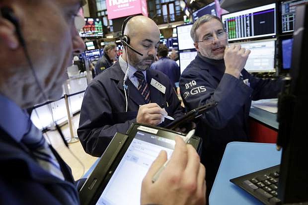 Trader Fred DeMarco, center, and specialist Anthony Rinaldi, right, work on the floor of the New York Stock Exchange, Thursday, Feb. 8, 2018. U.S. stocks are lower Thursday morning as losses from the previous day continue. (AP Photo/Richard Drew)