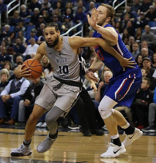 Nevada&#039;s Caleb Martin tries to drive around a Boise State player in the second half on Saturday.