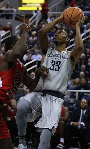 Nevada&#039;s Josh Hall fades away for a short jumper against Fresno State.