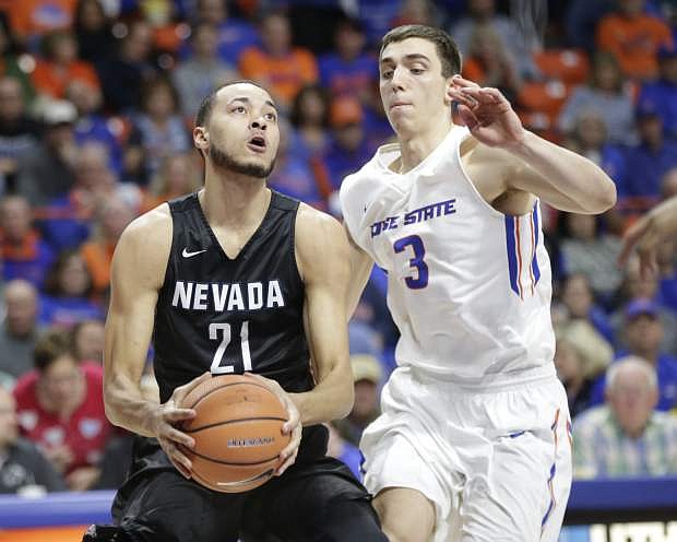 Nevada&#039;s Kendall Stephens (21) moves the ball against Boise State&#039;s Justinian Jessup (3) during the first half of an NCAA college basketball game in Boise, Idaho, Wednesday, Feb. 14, 2017. Nevada won 77-72. (AP Photo/Otto Kitsinger)