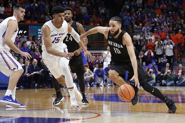 Nevada&#039;s Caleb Martin (10) moves the ball against Boise State&#039;s Chandler Hutchison (15) during Wednesday&#039;s game. The Wolf Pack plays at Utahe State on Saturday.