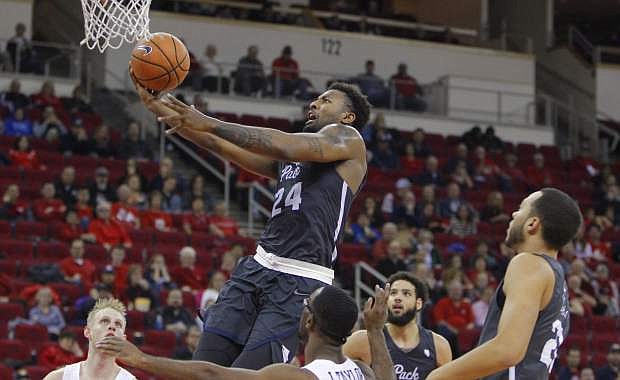 Nevada&#039;s Jordan Caroline goes in for a layup against Fresno State&#039;s Jahmel Taylor, front, during Wednesday&#039;s game.