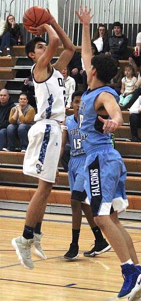 Oasis&#039;s Kenyen Hicks shoots a two-pointer over Coral Academy&#039;s Christopher Anders earlier this season.