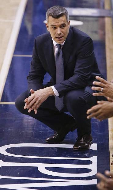 Virginia head coach Tony Bennett talks to his players during the first half of an NCAA college basketball game against Pittsburgh, Saturday, Feb. 24, 2018, in Pittsburgh. Virginia won 66-37. (AP Photo/Keith Srakocic)