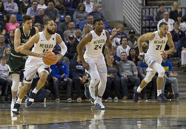Nevada&#039;s Cody Martin, left, leads a fast break against Colorado State in the first half of an NCAA college basketball game in Reno, Nev., Sunday, Feb. 25, 2018. (AP Photo/Tom R. Smedes)
