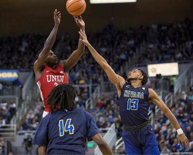 UNLV&#039;s Amauri Hardy shoot over Nevada&#039;s Hallice Cooke, right, during the first half of an NCAA college basketball game in Reno, Nev., Wednesday, Feb. 7, 2018. (AP Photo/Tom R. Smedes)