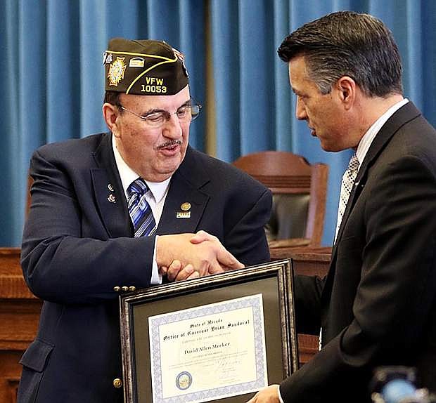 Gov. Brian Sandoval, right, recognizes David Meeker as Veteran of the Month.