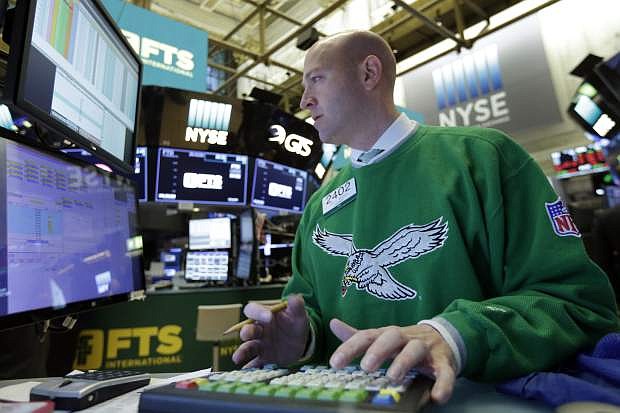 Specialist Jay Woods wears a vintage Philadelphia Eagles sweater as he work at his post on the floor of the New York Stock Exchange, Monday, Feb. 5, 2018. Stock markets around the world took another pummeling Monday as investors continued to fret over rising U.S. bond yields. (AP Photo/Richard Drew)