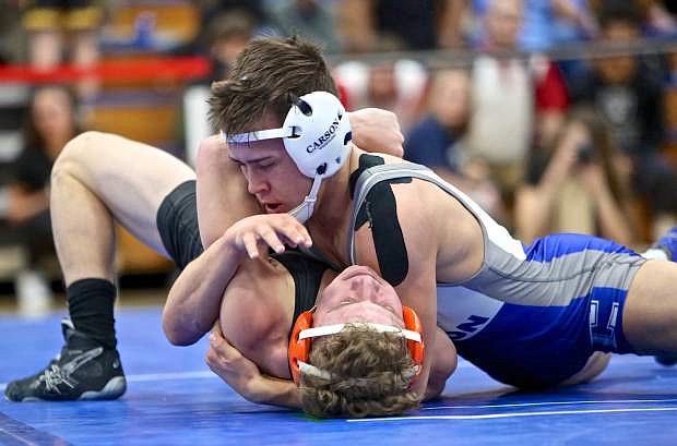 138-pounder Kyle Rudy on his way to pinning Douglas&#039; Race Coman during the first day of regional competition at Carson High School.