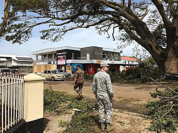 Brig. Gen. Bill Burks, foreground, the adjutant general of Nevada, surveys the destruction on the island of Tongatapu in Tonga on Tuesday following Tropical Cyclone Gita, a category four cyclone that landed on Tonga on Monday.
