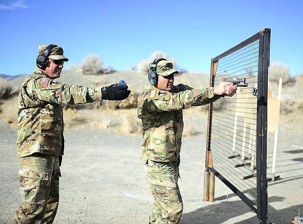 Master Sgt. Michael Clark, right, receives instruction from Maj. Robert Kolvet during a mock final shooting test for Nevada National Guard unit marshal applicants in December 2017 at a shooting range near Carson City, Nev. The Unit Marshal Program allows Guardsmen to carry their personally owned firearms concealed while on Nevada Guard property as a deterrent to active assailants and insider threats.