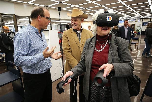 Mark Anderson, with Lifeliqe, teaches Phil and Phyllis Patton about virtual reality during the Grand Reopening Ceremony at the Carson City Library in Carson City, Nev., on Friday, Feb. 16, 2018. Photo by Cathleen Allison/Nevada Momentum