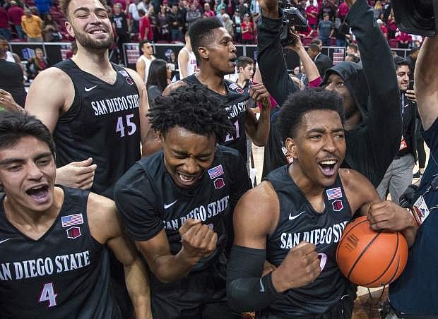 San Diego State players celebrate their 82-75 win against New Mexico in the Mountain West Conference championship Saturday in Las Vegas.