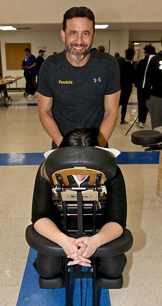Matt Pendola of Bodhi Tree Massage Therapy demonstrates his chair massage technique Wednesday night.