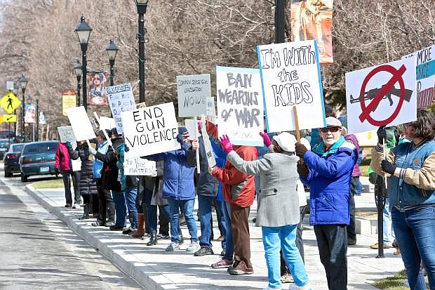 Marchers stand along Carson St. in front of the Legislative Building Saturday afternoon.