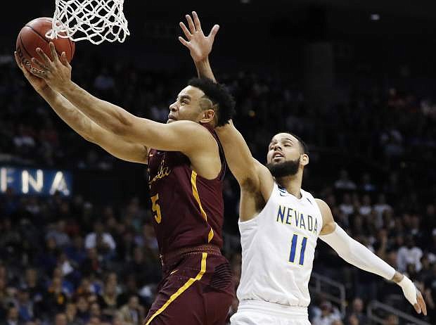 Loyola-Chicago guard Marques Townes (5) moves to the hoop as Nevada forward Cody Martin (11) defends during the second half of Thursday&#039;s regional semifinal in Atlanta.