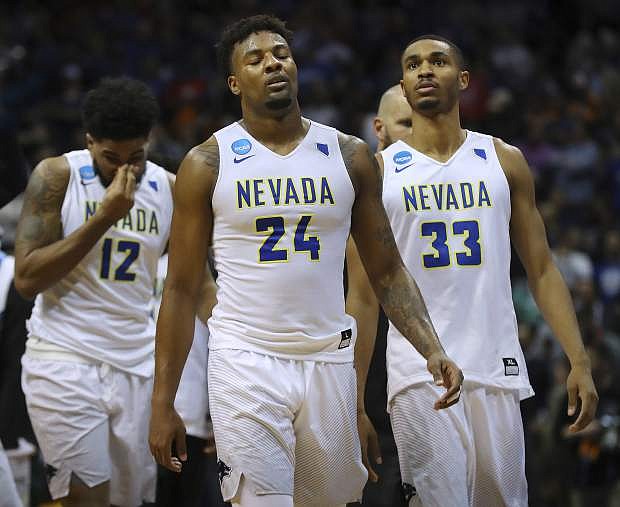 Nevada&#039;s Elijah Foster, Jordan Caroline, and Josh Hall, from left, walk off the court after the team&#039;s 69-68 loss to Loyola-Chicago during an NCAA men&#039;s college basketball tournament regional semifinal Thursday, March 22, 2018, in Atlanta. (Curtis Compton/Atlanta Journal-Constitution via AP)
