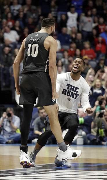 Nevada forward Caleb Martin (10), celebrates with a teammate at the end of the second half of a second-round game against Cincinnati, in the NCAA college basketball tournament in Nashville, Tenn., Sunday, March 18, 2018. Nevada defeated Cincinnati 75-73. (AP Photo/Mark Humphrey)
