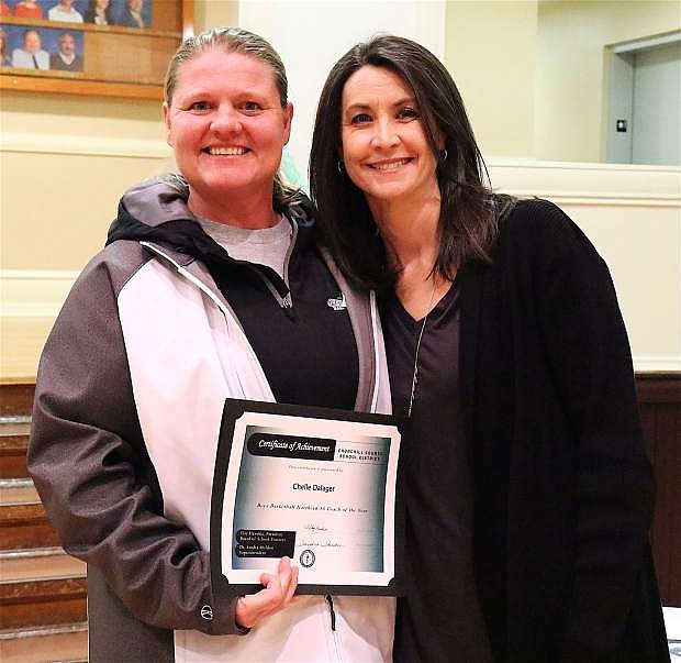 Trustee Tricia Strasdin, right, presents the 2018 Coach of the Year award to Churchill County High School Boys Basketball Coach Chelle Dalager at the March 14 meeting.