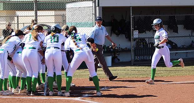 The Lady Wave wait for teammate Stacy Kalt, who crushed a first-inning homer Friday against South Tahoe.