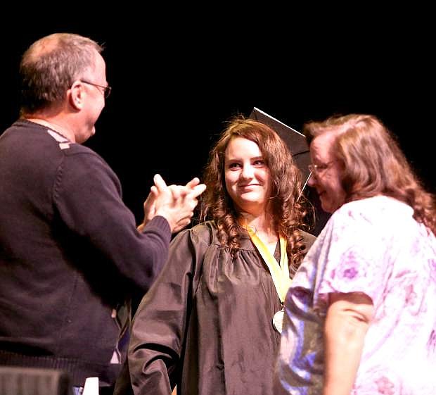 Argent Preparatory Academy 2018 Valedictorian Allison Rasmussen is congratulated onstage by her parents at graduation ceremonies Thursday everning.