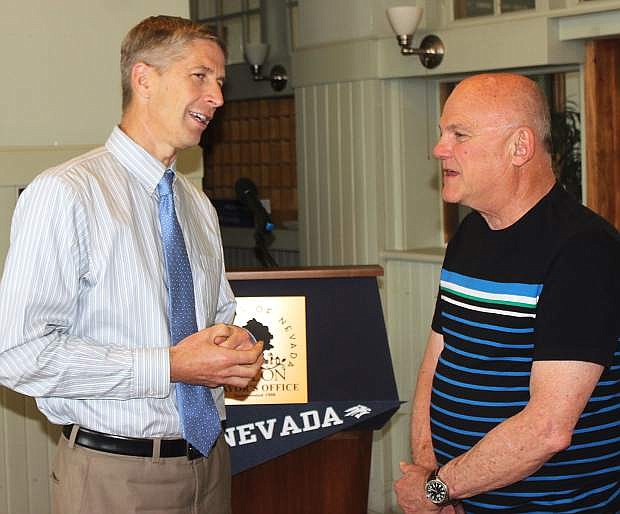 Nevada Athletics Director Doug Knuth talks to Wolf Pack booster Roger Diedrichsen.