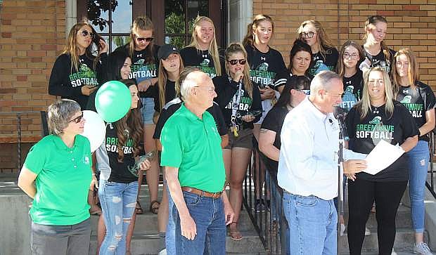 Council members Kelly Frost, left, and Bob Erickson, center, congratulate the softball team along with Mayor Ken Tedford.