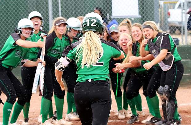 Fallon senior Stacy Kalt ends the game with a three-run homer and is welcomed by her teammates at home plate.