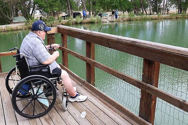 Mike Bohn sings and makes jokes as he enjoys his Wednesday morning fishing with friends at Liberty Pond with The Homestead Assisted Living.