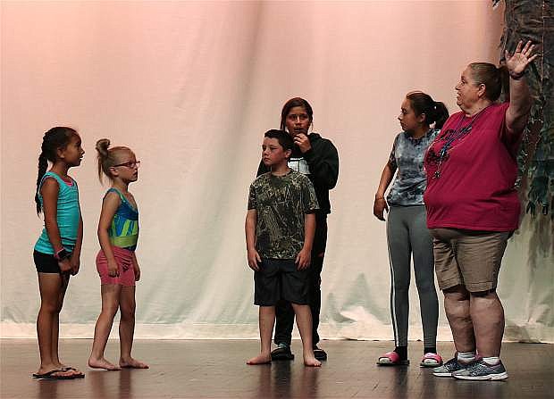 Ivy Ward, far right, directs her students during rehearsals for Alice in Wonderland at the Churchill County High School auditorium, along with CCHS Ballroom team.