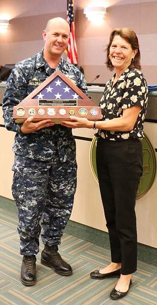 During the commissioners meeting May 16, Captain David Halloran, Commanding Officer Navel Air Station, presented County Manager Eleanor Lockwood a flag with 10 command coins from each command, as a token of oath.