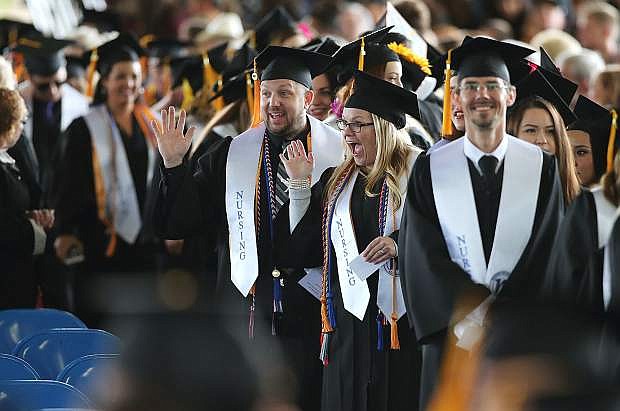 Nursing graduates wave to family and friends during the 2018 Western Nevada College Commencement Ceremony on Monday in Carson City. Forty-one nursing students were among 539 graduates.
