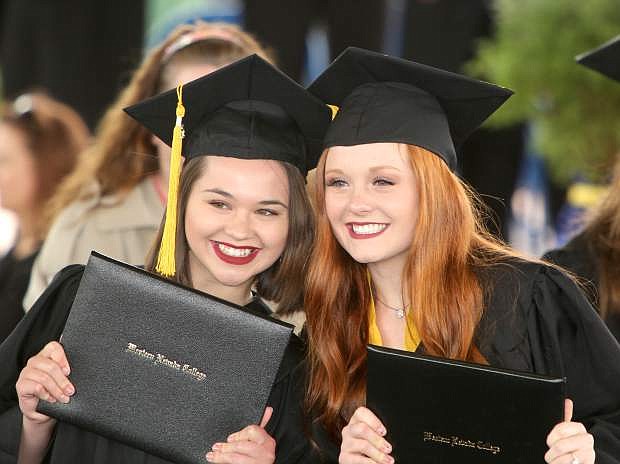 Carson High School students Maddison Gillott and Alexa Haight, who completed the Jump-Start program pose for a picture holding their Western Nevada College diplomas.