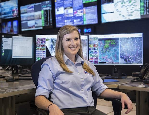 In this Friday, May 4, 2018, photo, Meteorologist Chelsea Kryston sits at the National Weather Service in Las Vegas. With all the technological advances in weather forecasting over the years, National Weather Service officials in Las Vegas and across the country still rely on a decades-old practice to fine tune their outlook _ twice-daily launching of weather balloons. (Benjamin Hager/Las Vegas Review-Journal via AP)