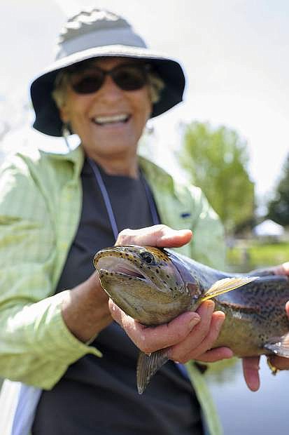 Jennifer Pahl, a breast cancer survivor of Carson City, holds the fish she caught during the Casting for Recovery fishing clinic at Bently Ranch in Gardnerville on Friday.