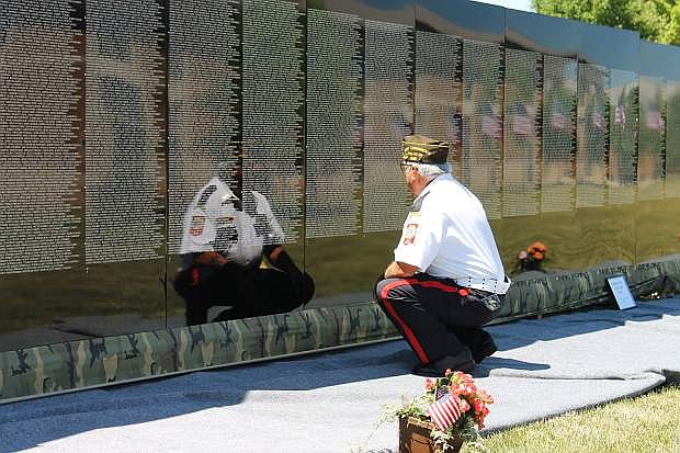 Vietnam War Navy veteran Dave Varisco pauses to reflect in front of his two old high school friends at Medina High School in Cleveland, Ohio. The Moving Wall will be installed at Eastside Memorial Park Thursday through June 4.