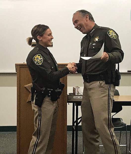 Newly sworn in Deputy Samantha Torres shakes hands with Carson City Sheriff Ken Furlong on Thursday.
